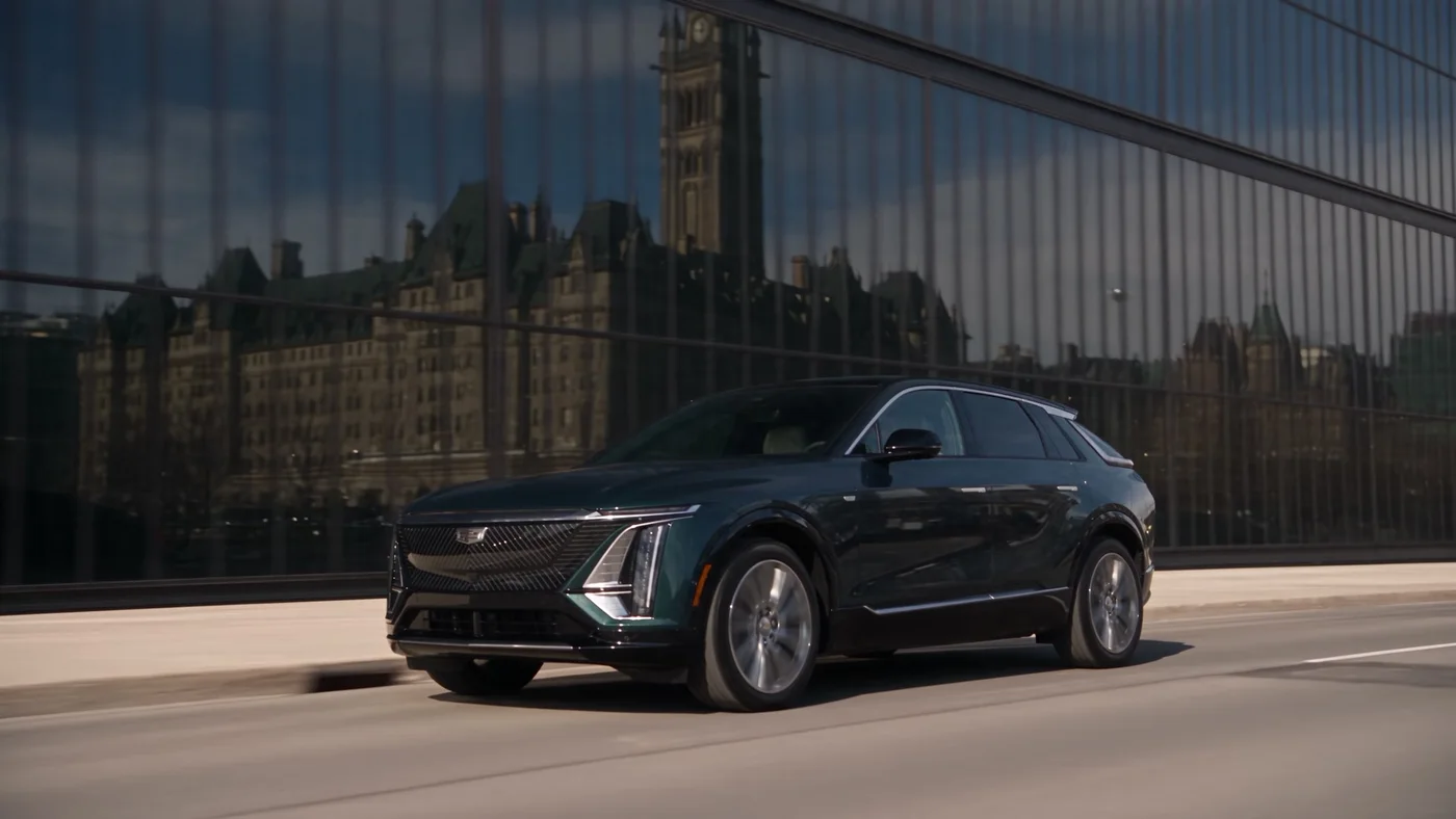 Black Cadillac driving past Ottawa architecture
